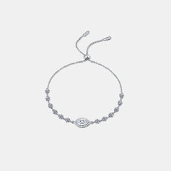 Sterling silver moissanite bracelet with white stones and a small blue stone centerpiece