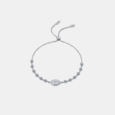 Sterling silver moissanite bracelet with white stones and a small blue stone centerpiece