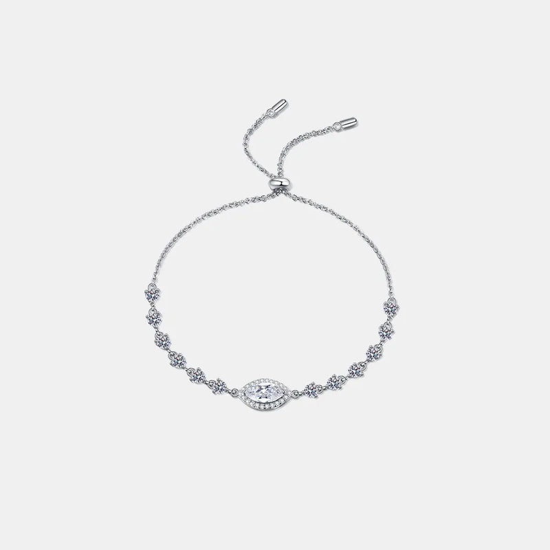 Sterling silver moissanite bracelet with white stones and a small blue stone centerpiece