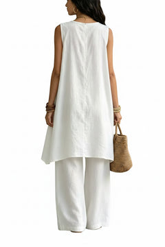 Sleeveless asymmetrical top and wide-leg pants set in white, back view