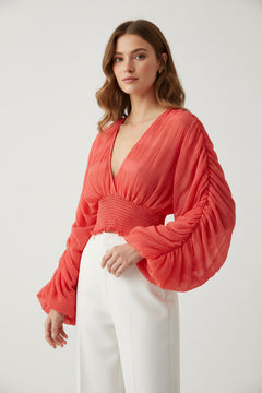 Coral long-sleeve blouse with V-neck and smocked ruched waist, voluminous sleeves