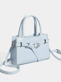 Light blue top-handle handbag with buckle strap detail and crossbody strap