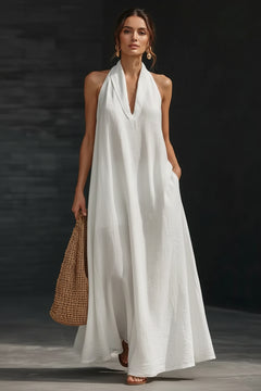 White halter neck sleeveless maxi dress with deep V-neck and flared silhouette
