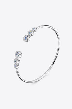 Silver-tone open cuff bracelet with five round clear stones, side view