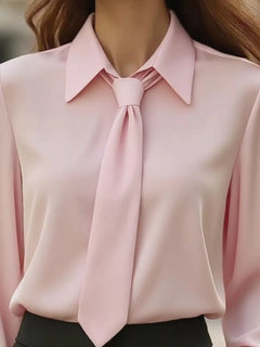 Pink blouse with pointed collar and tie bow at neckline