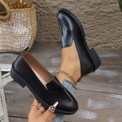 Black loafers with round toe, V-cut vamp, and ankle chain strap detail