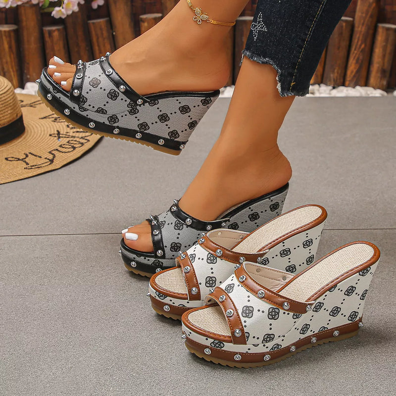 Peep toe wedge sandals with black-and-white patterned uppers and studded straps