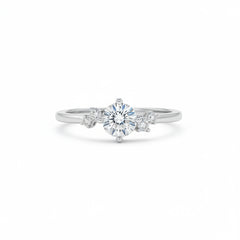 Sterling silver solitaire ring with round moissanite center and four side stones