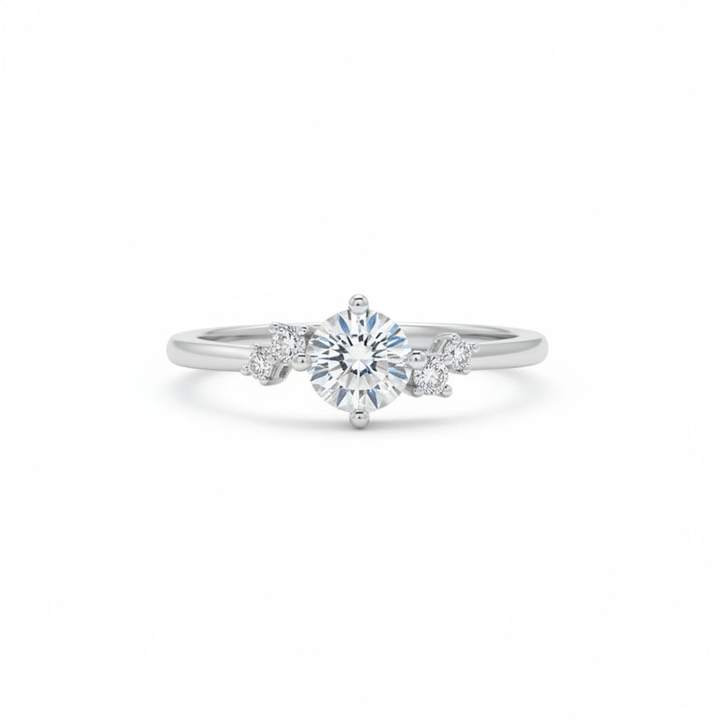 Sterling silver solitaire ring with round moissanite center and four side stones