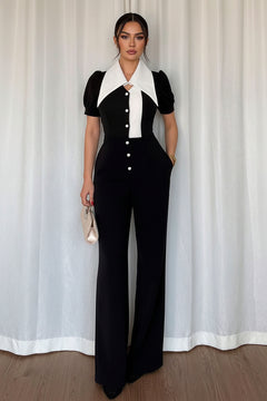 Black wide-leg jumpsuit with contrast white collar and front panel, button details