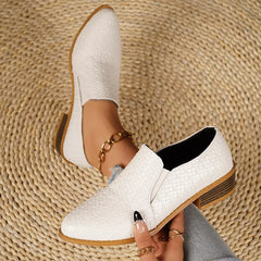Point-toe block heel loafers in white with textured finish and gold chain detail.