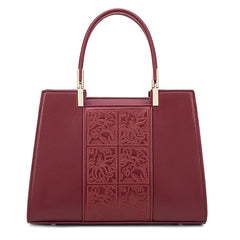 Red embossed leather top-handle handbag with carved front panel