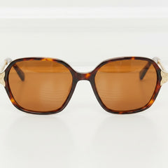 Brown tortoiseshell full-rim sunglasses, oval amber lenses and split metal bridge