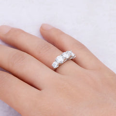 925 sterling silver moissanite band ring with three round clear stones, worn on hand