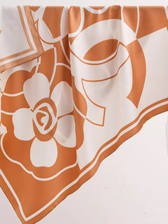 Square flower silk scarf close-up with sherbet orange and white floral graphics