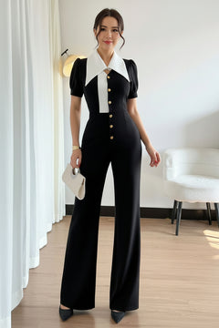 Black wide-leg jumpsuit with contrast white panel, button placket, and short puff sleeves