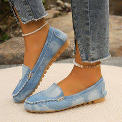 Light blue denim round-toe flat loafers with metal buckle and beaded ankle chain