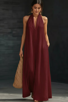 Burgundy halter neck sleeveless maxi dress with deep V-neck and flowing hem