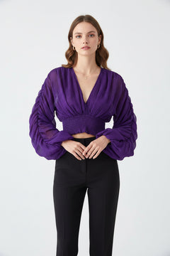 Purple long-sleeve blouse with V-neck and ruched smocked waist, gathered cuffs