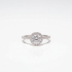 Round halo moissanite solitaire ring with pavé-set side detail on sterling silver
