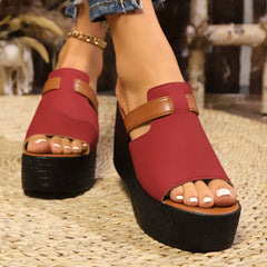 Open-toe wedge sandals with red upper and tan ankle strap on black platform
