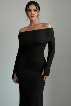 Black off-shoulder long sleeve maxi dress, fitted silhouette with draped neckline.