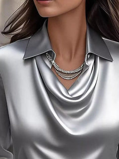 Silver gray satin cowl neck blouse with draped V neckline and pointed collar detail