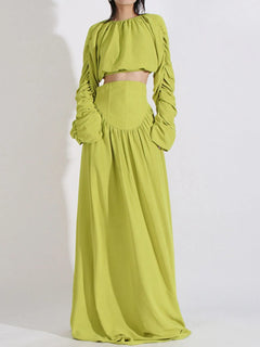 Green ruched long-sleeve crop top and high-waist maxi skirt set, tied waist detail