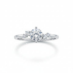 Sterling silver solitaire ring with round moissanite center and two small side stones