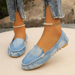 Light blue denim round-toe flat loafers with buckle detail and pearl ankle chain strap
