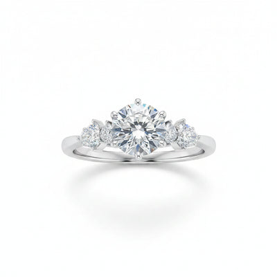 Sterling silver moissanite three-stone ring with round center stone and side stones, prong set