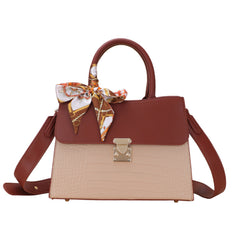Top-handle handbag with shoulder strap; burgundy top and handles, beige crocodile-embossed body