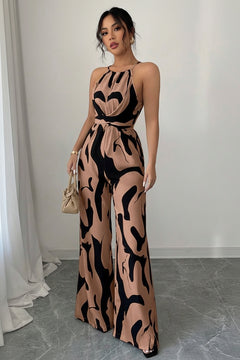 Sleeveless wide-leg jumpsuit with abstract tan-and-black print and tied waist detail