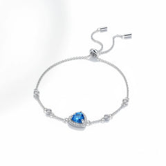 925 sterling silver bracelet side view with blue heart gemstone and round halo stones