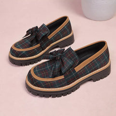 Pair of plaid chunky loafers with front bows, teal plaid uppers and chunky sole