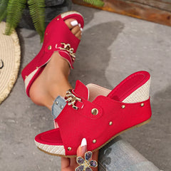 Rose red open-toe wedge sandals with chain buckle strap and metal stud detail.
