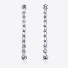 Silver drop earrings with round moissanite stones in a line