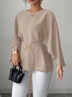 Beige batwing sleeve belted blouse with square buckle at waist, draped flare hem