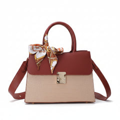 Top-handle handbag with shoulder strap, burgundy handles, beige crocodile-embossed body, scarf bow