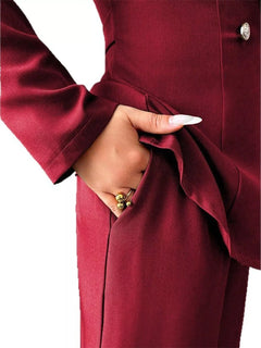 Burgundy pants set detail: gold-button blazer cuff and tied waist sash