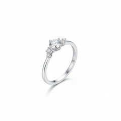 Sterling silver solitaire ring with round moissanite center and clustered side stones