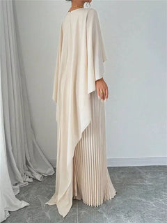 Cream pleated maxi dress side view with cape overlay and pleated skirt