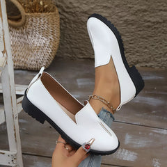 White loafers with round toe, V-cut front, and ankle chain strap detail