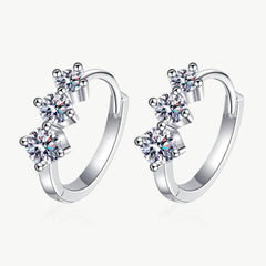 Sterling silver huggie hoop earrings with hinged hoops and three round moissanite stones