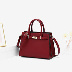 Burgundy leather handbag with front clasp and detachable shoulder strap