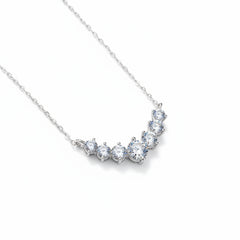 925 sterling silver moissanite necklace with round stones in a curved V design
