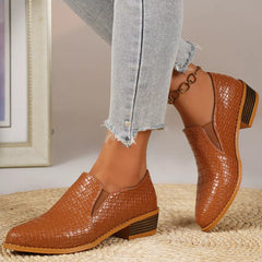Point-toe block heel loafers in tan/brown with textured finish and gold chain ankle detail.