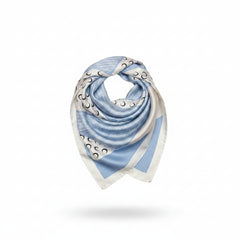Printed silk square scarf draped in light blue with crescent moon pattern