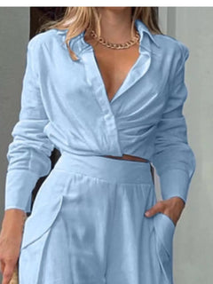 Light blue wrap-style long-sleeve shirt with V-neck and cinched waist