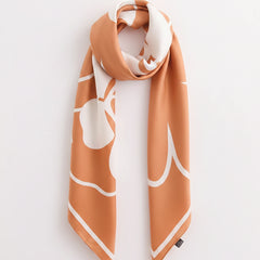 Square flower silk scarf draped, sherbet orange and white with outlined flower